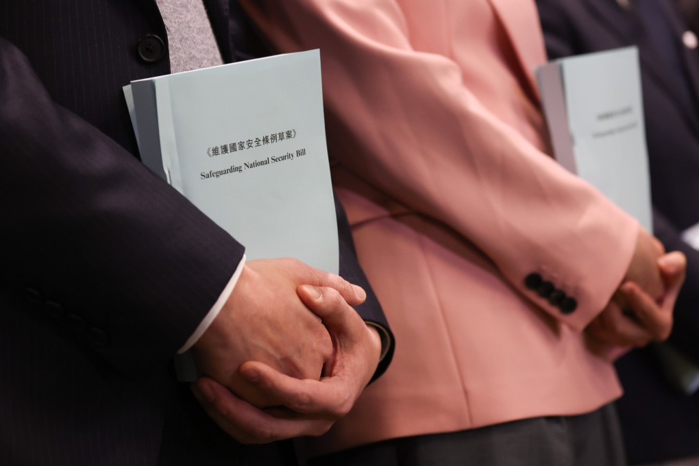 Lawmakers hold copies of the Safeguarding National Security Bill. Quick passage  of the proposed legislation is expected, perhaps by April 15, China’s National Security Education Day. Photo: Yik Yeung-man