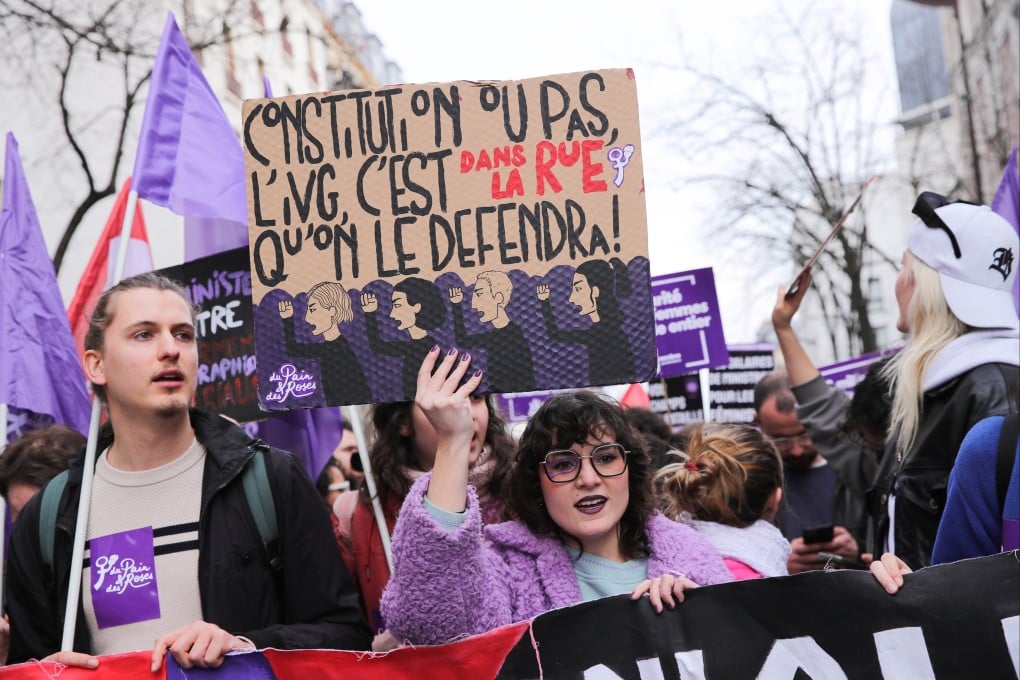 A participant holds a sign reading ‘Constitution or not, we’ll defend abortion rights in the streets’ during a rally for International Women’s Day in Paris on Friday. Photo: EPA-EFE