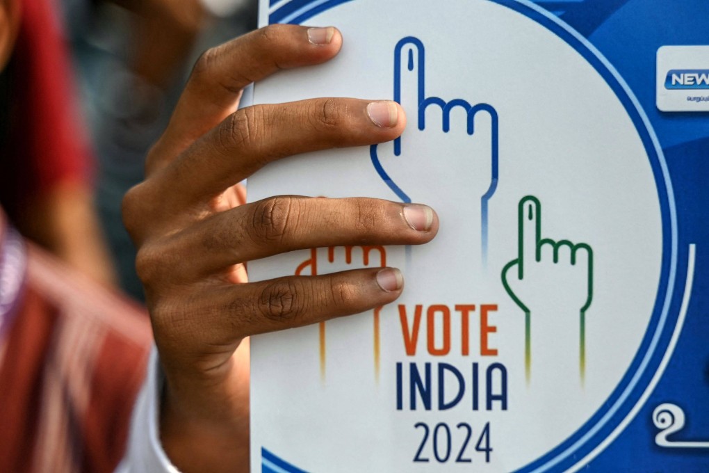 A student in India holds a placard on Saturday during a rally to create awareness about the importance of voting. Photo: AFP