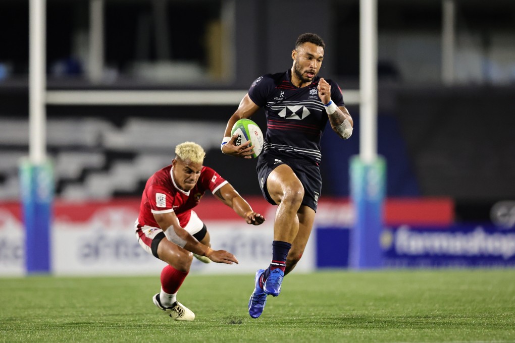 Hong Kong’s Max Denmark skips out of a Tonga tackle in Montevideo. Photo: KLC fotos for World Rugby