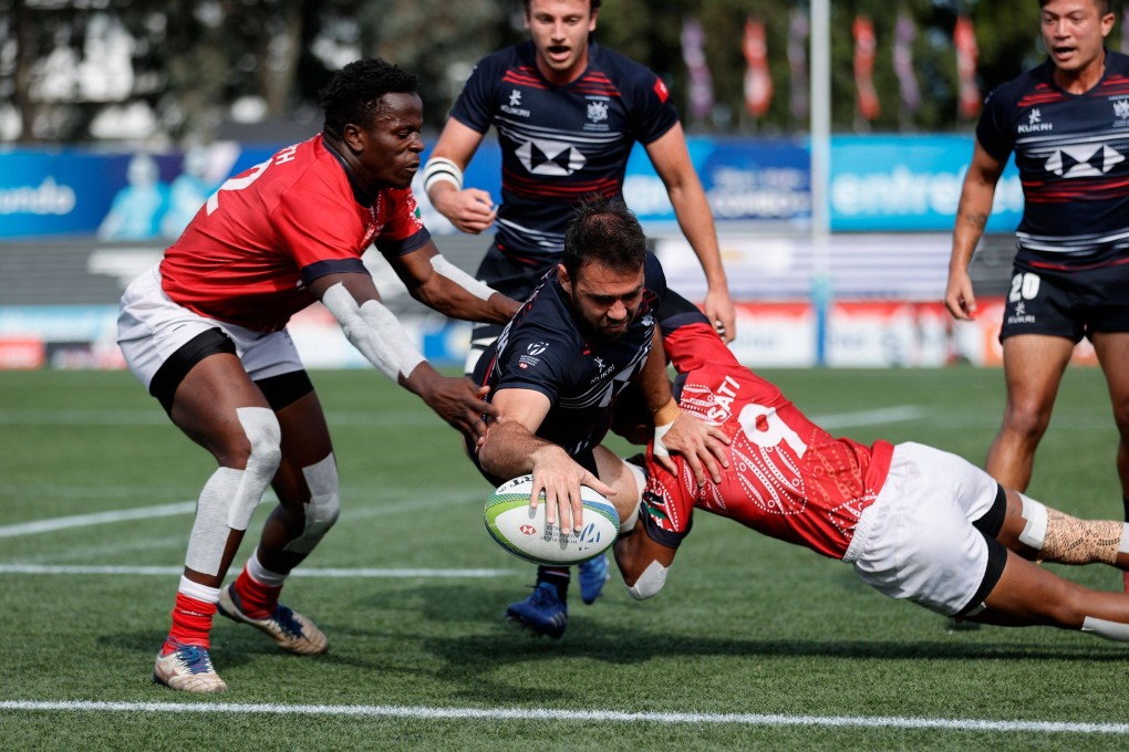 Hong Kong’s Callum McCullough dives over to score against Kenya in the semi-final in Montevideo. Photo: KLC fotos for World Rugby