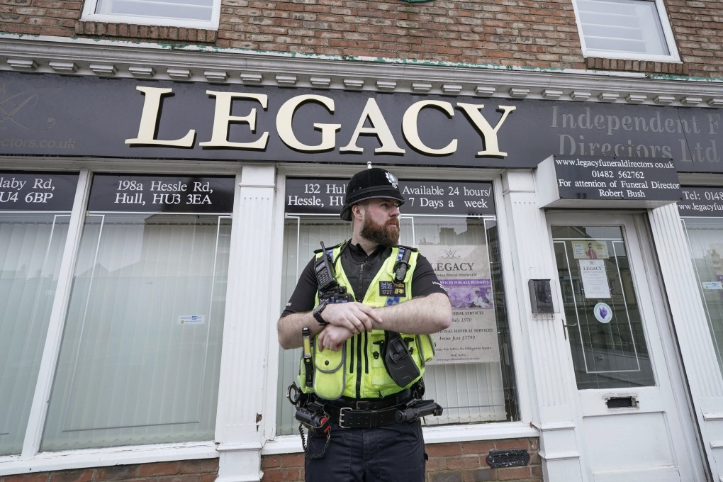 A police officer stands guard outside the Beckside branch of Legacy Independent Funeral Directors in Hull, England,
UK on Saturday. Photo: PA via AP
