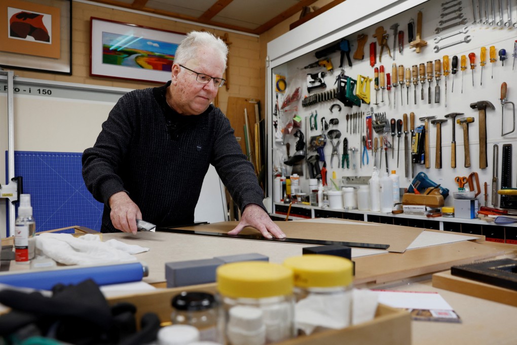 Bert Janssen, 57, works in his framing company in Herkenbosch, the Netherlands. He underwent a heart transplant at the age of 17, almost 40 years ago, receiving a donor heart which is now immortalised in the Guinness Book of Records. Photo: Reuters