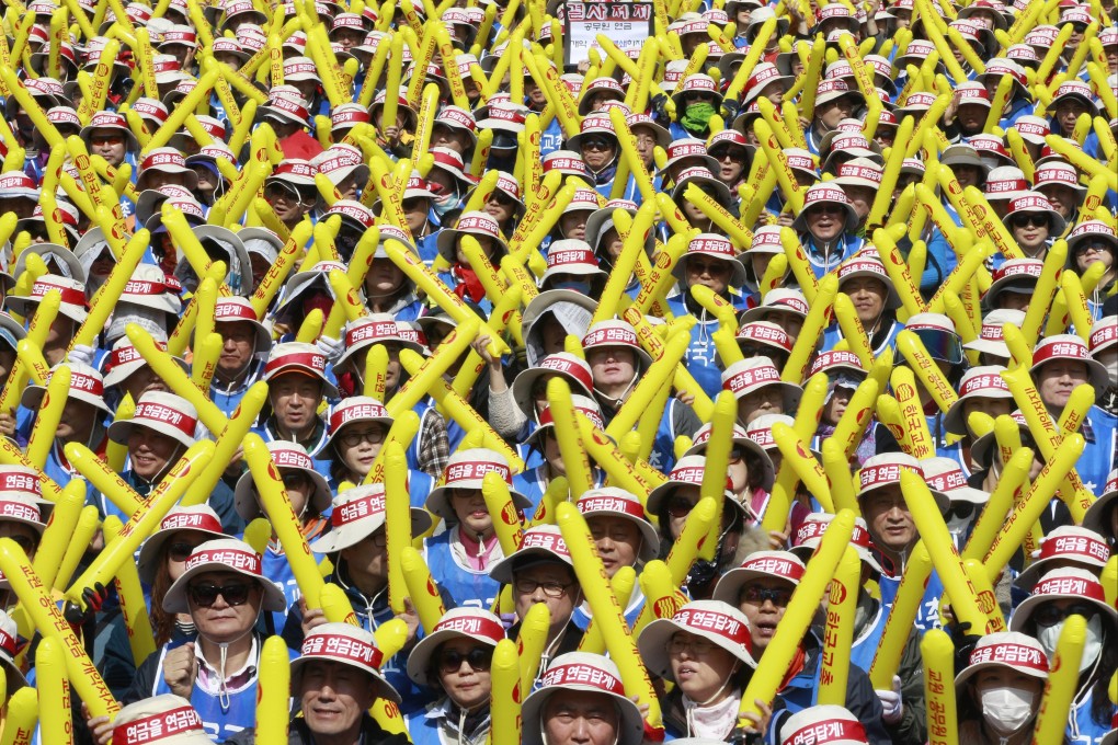 Unionized civil servants beat their balloon sticks during a rally to oppose the government’s overhaul of the public pension system near the National Assembly in Seoul on March 28, 2015. Photo: AP