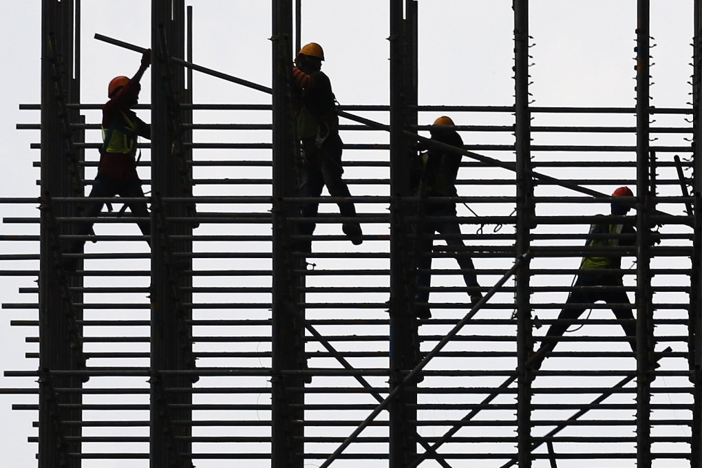 Construction workers in Kuala Lumpur. Migrant workers have been instrumental in the rapid growth of Malaysia’s gleaming skyscrapers and infrastructure projects. Photo: EPA-EFE