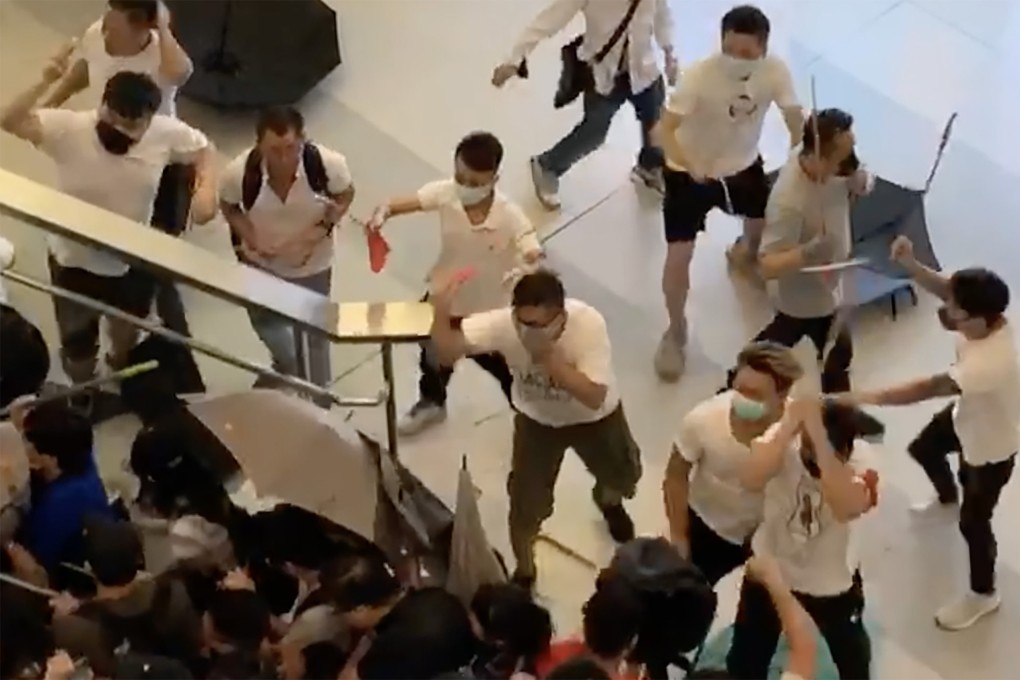 A screengrab from a video showing a number of people in white with wooden sticks chasing and assaulting people at Yuen Long Station in 2019. Photo: Handout