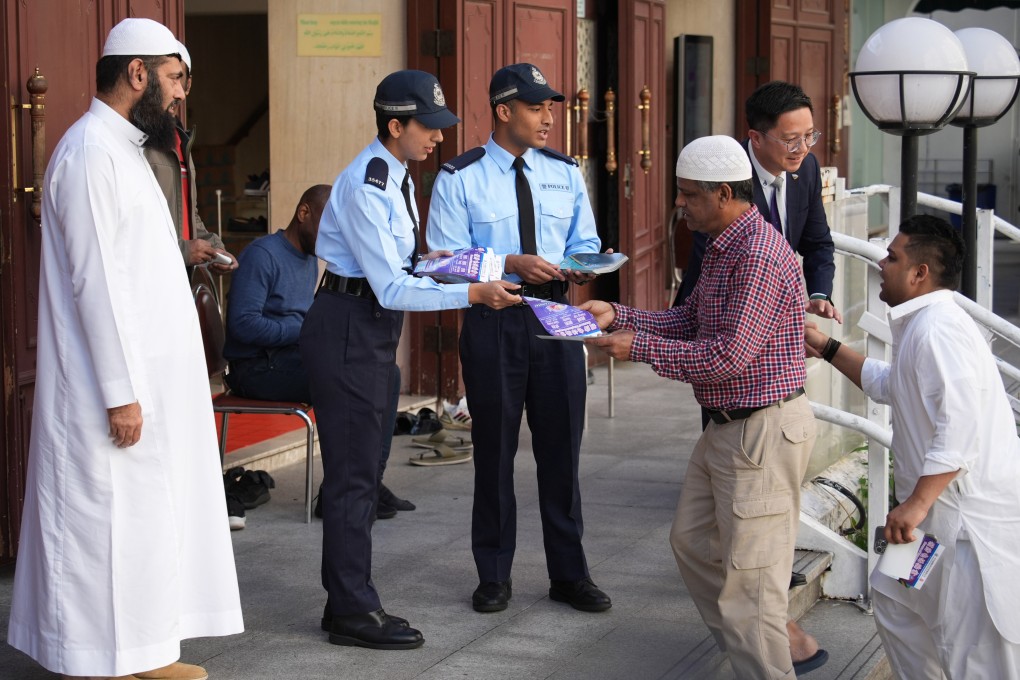 Constables Adnan Mohammad (third left) and Salma Bibi (second left) distribute anti-scam leaflets in Kowloon. They are among the more than 150 officers from an ethnic minority background. Photo: Eugene Lee