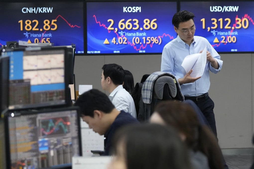 Traders at KEB Hana Bank headquarters in Seoul, South Korea, on March 12, 2024. AP Photo.