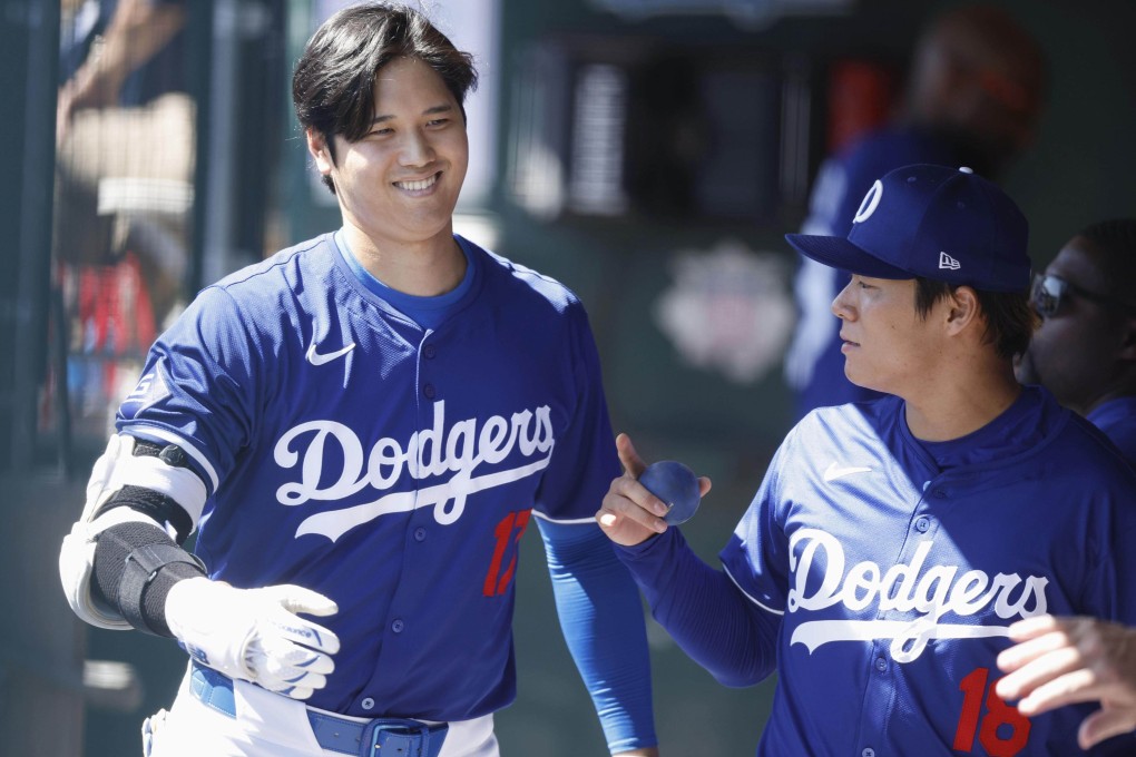 Shohei Ohtani (left) chats with teammate Yoshinobu Yamamoto during a spring training game against the Seattle Mariners in Arizona on Wednesday. Photo: Kyodo