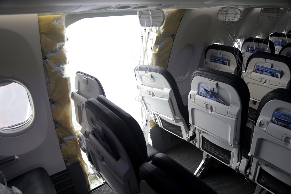 A gaping hole is seen where a paneled-over door had been at the fuselage plug area of Alaska Airlines Flight 1282. Photo: National Transportation Safety Board via AP