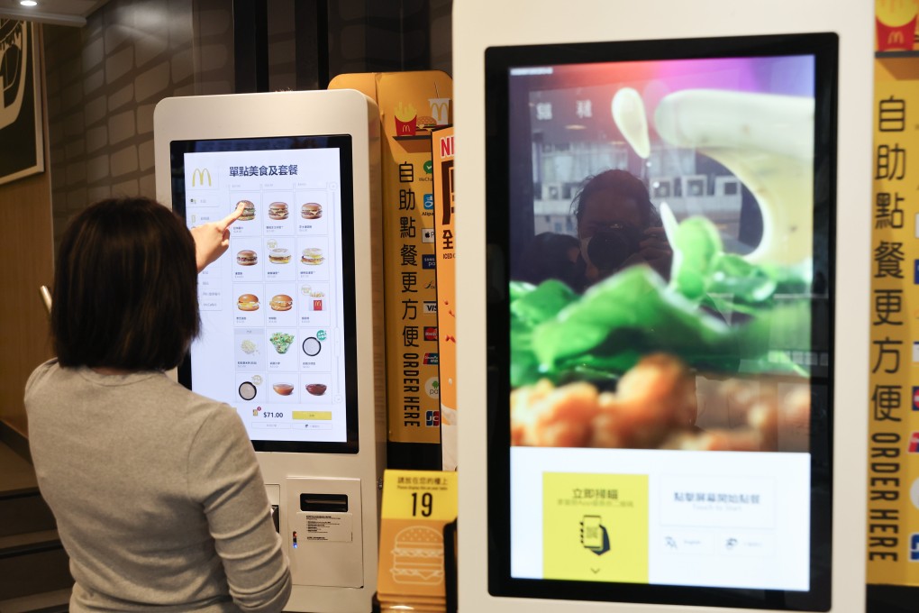A customer scrolls through a  McDonald’s self-order kiosk in Tin Hau. The fast food chain’s app and kiosks in stores experienced an outage on Friday, the company said. Photo: Edmond So