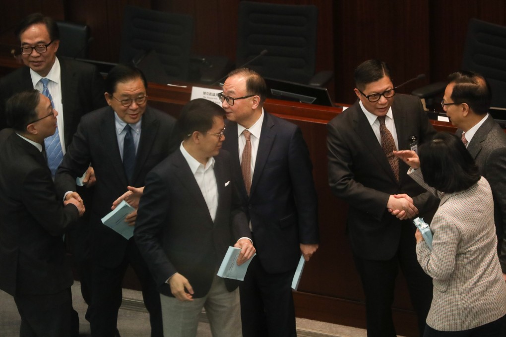 Lawmakers greet government ministers after the bills committee meeting on Thursday. Photo: Sun Yeung