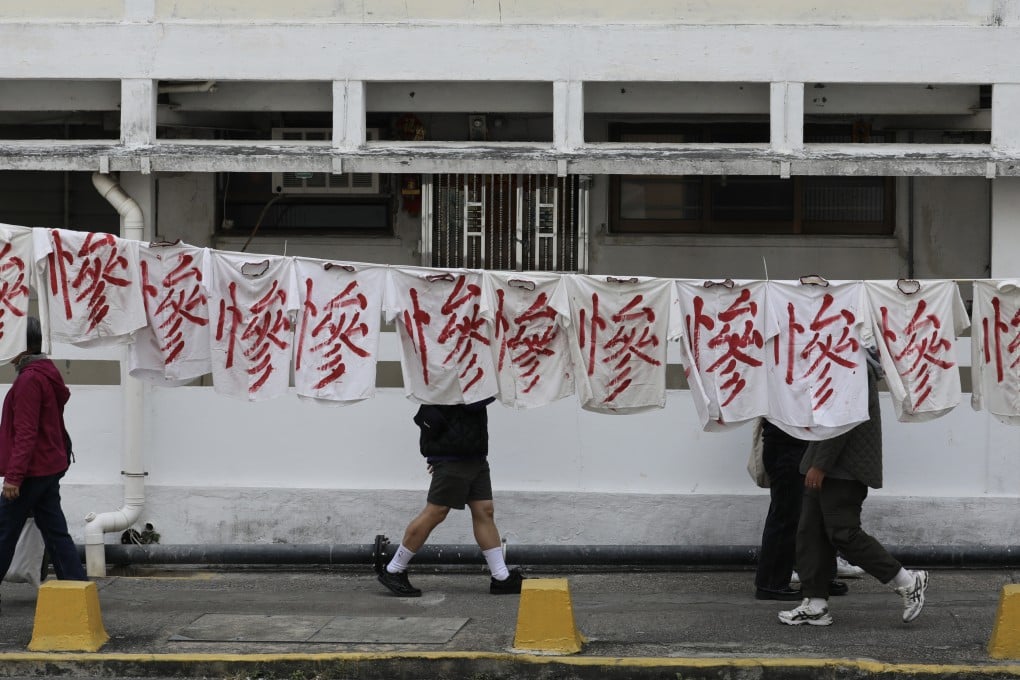 A banner hangs in protest against the relocation of residents from the Tai Hang Sai Estate. Two of the site’s eight blocks were built as early as 1964. Photo: Xiaomei Chen