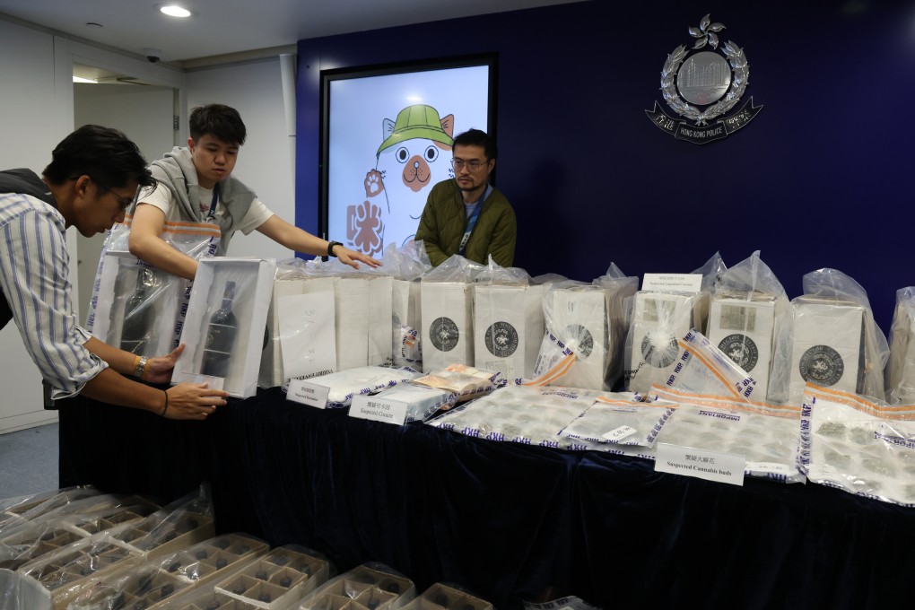 A Hong Kong police narcotics bureau press conference displays illegal drugs seized during an investigation, including 214 kilograms of suspected liquid cocaine, one kilogram of suspected cocaine, a small amount of cracked cocaine and other illegal drugs valued at about $215 million. Photo: Jelly Tse