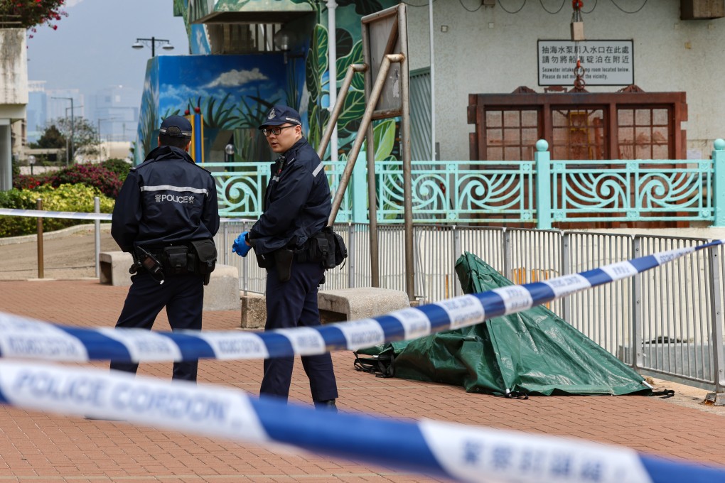 Police stand beside the covered human remains. Personnel from the Fire Services Department brought the remains ashore. Photo: Dickson Lee