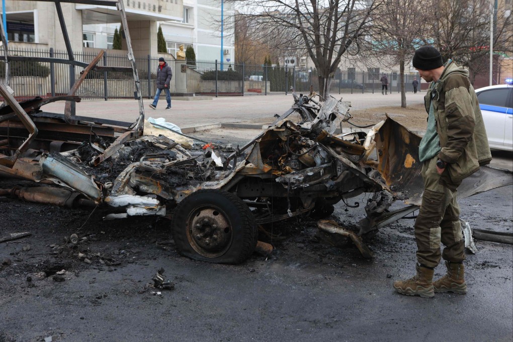 A man looks at the wreckage of a vehicle after aerial attacks on Belgorod, Russia, on Saturday. Photo: AFP