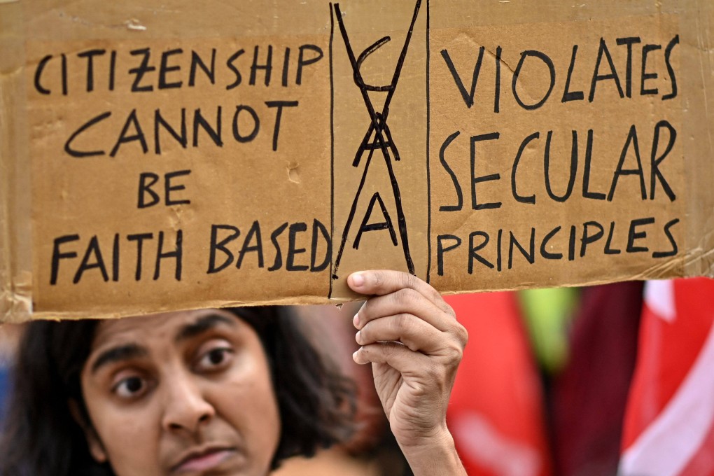 A member and activist of left-wing organisations holds a placard during a protest against the implementation of the Citizenship Amendment Act in Bengaluru, India, on March 13. Photo: AFP