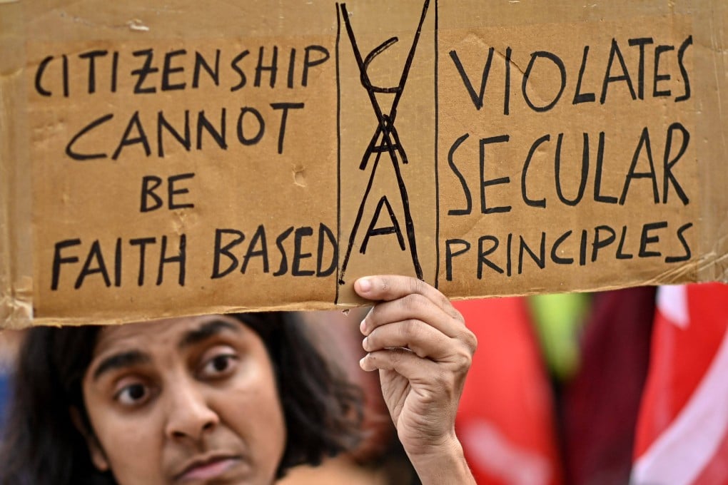 A member and activist of left-wing organisations holds a placard during a protest against the implementation of the Citizenship Amendment Act in Bengaluru, India, on March 13. Photo: AFP