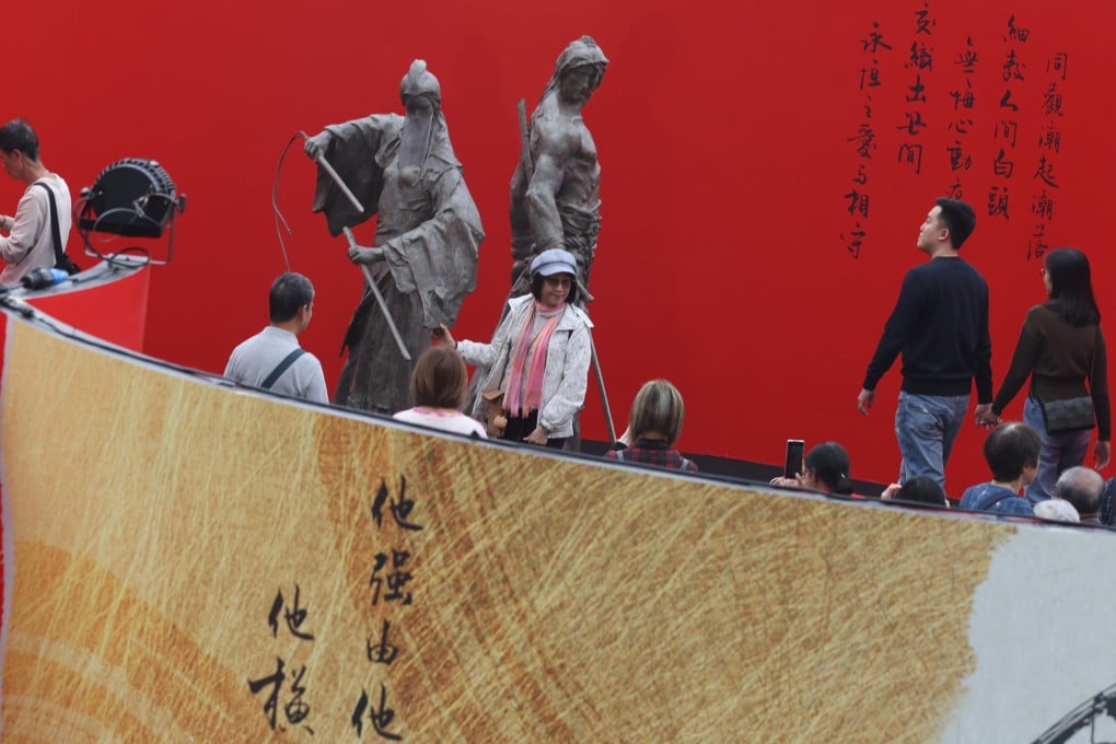 Visitors at an exhibition in Edinburgh Place, Central, celebrating the 100th birthday of late novelist Jin Yong. Photo: Yik Yeung-man