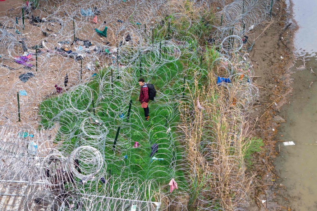 An immigrant faces coils of razor wire after crossing the Rio Grande from Mexico into the United States on March 17 in Eagle Pass, Texas. Texas National Guard troops have fortified Eagle Pass with vast amounts of razor wire as part of Governor Greg Abbott’s “Operation Lone Star” to deter migrants from crossing into Texas. Photo: AFP