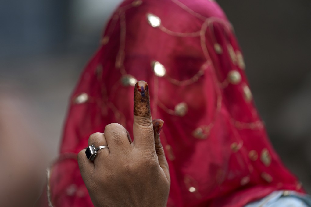 A woman in Hyderabad shows the indelible ink mark on her finger after casting her vote in November’s Telangana state assembly elections. Photo: AP