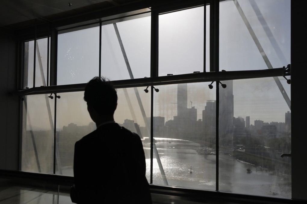 A man looks out from a window at the Futian-Lok Ma Chau Pedestrian Bridge. A University of Hong Kong official said the suicide prevention system would launch in two to three months. Photo: Xiaomei Chen