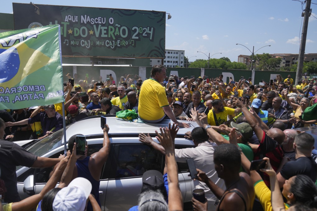 Brazil’s former president Jair Bolsonaro greets supporters after attending a campaign event launching the pre-candidacy of a mayoral candidate, in Rio de Janeiro. Photo: AP