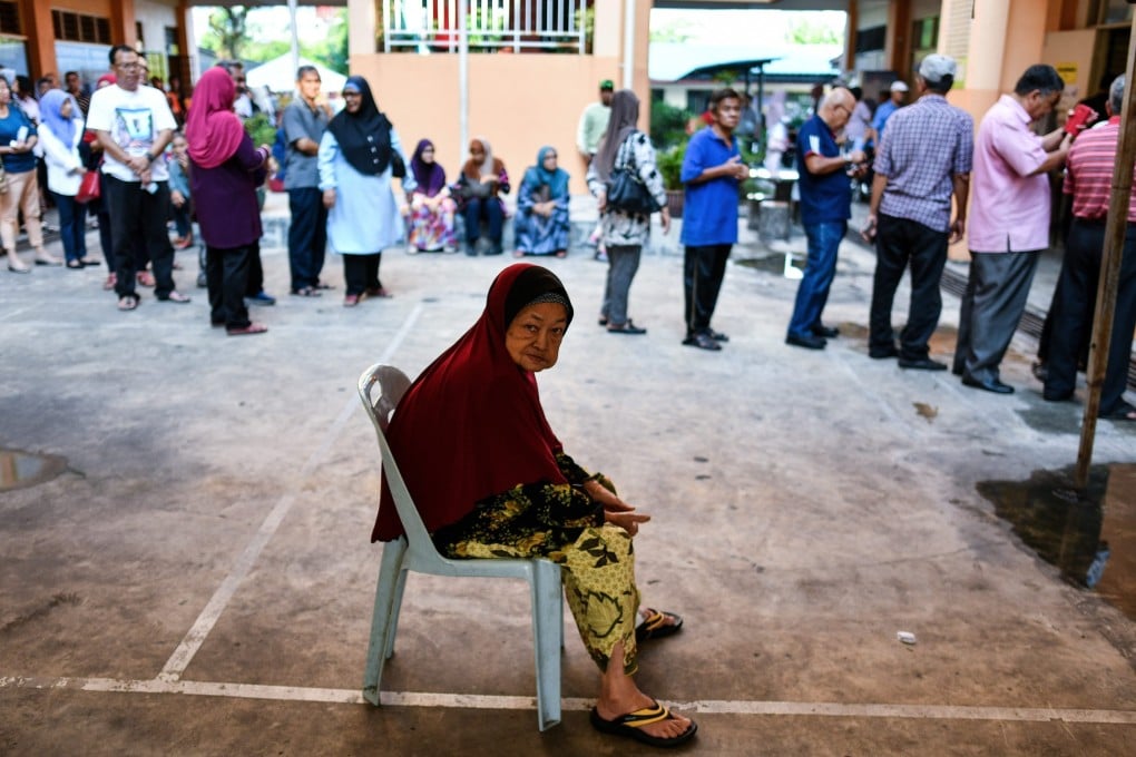 An elderly Malaysian woman waits to cast her vote at a polling station in Kuala Lumpur during the general election in 2018. Photo: AFP