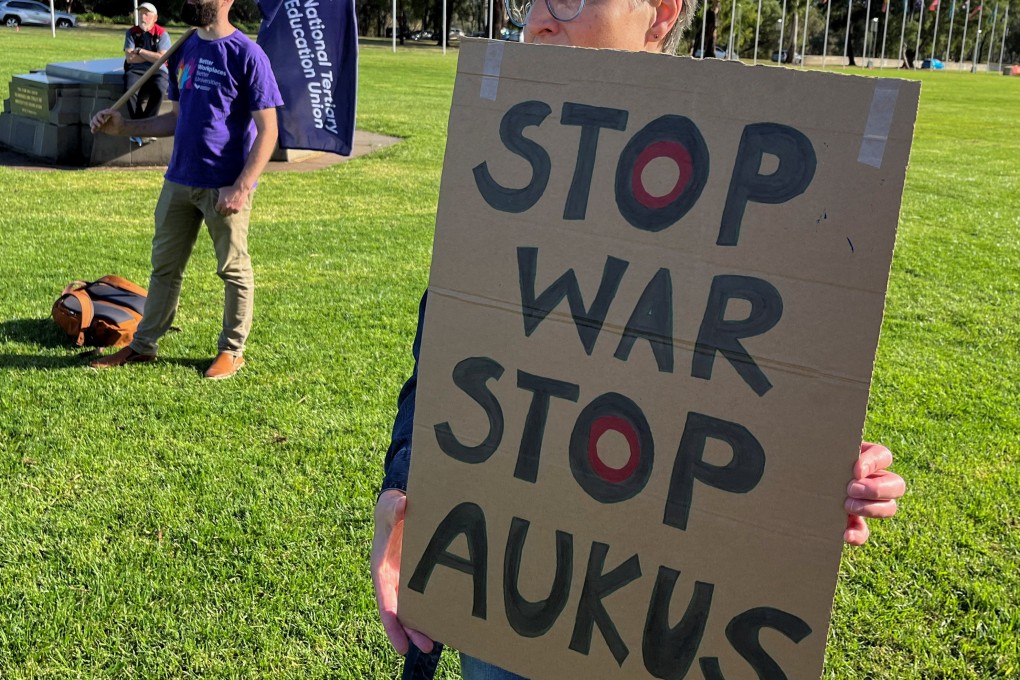 Anti-Aukus protesters stand outside Australia’s parliament in Canberra on Monday. Photo: Reuters