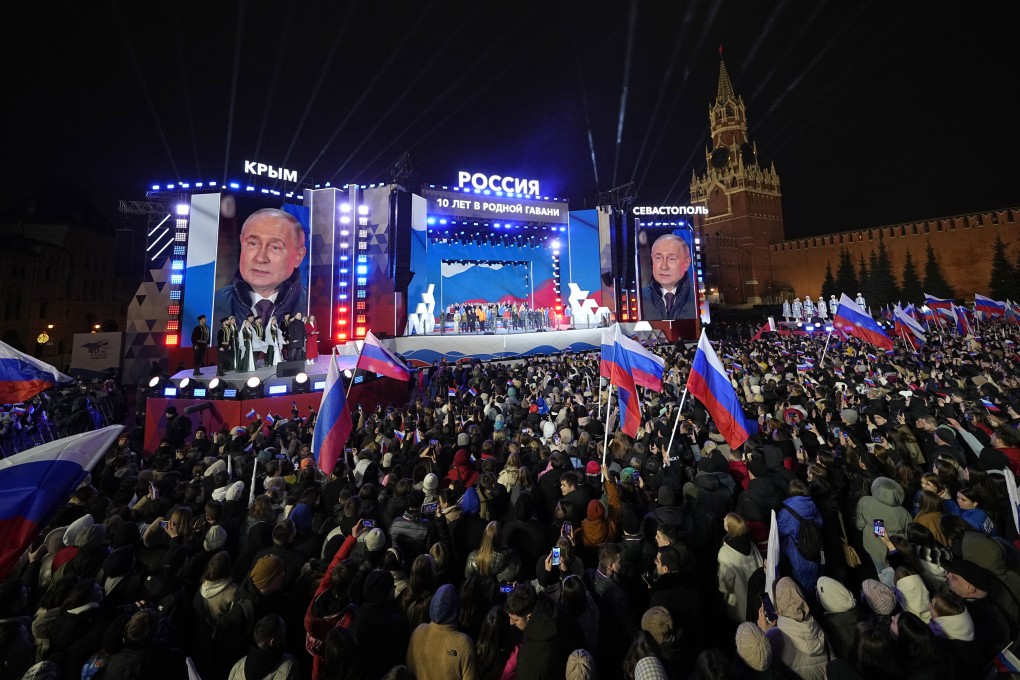 Russian President Vladimir Putin is seen on screens in Moscow’s Red Square as he celebrates his re-election victory. Photo: AP