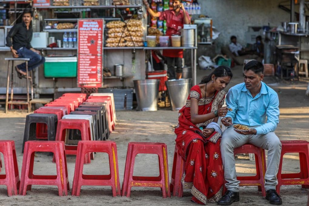 An Indian couple enjoys some street food in Mumbai. Official data shows the total fertility rate in India has dropped 20 per cent in the last 10 years to below replacement levels. Photo: EPA-EFE