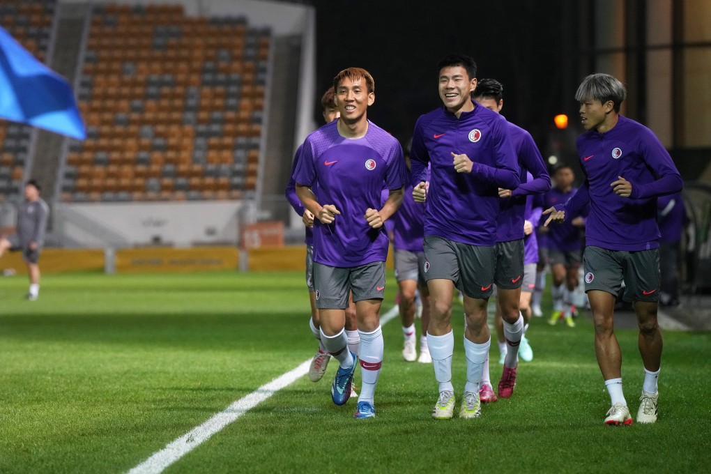 Hong Kong players jog around the Mong Kok Stadium pitch ahead of a World Cup qualifier against Uzbekistan. Photo: Elson Li