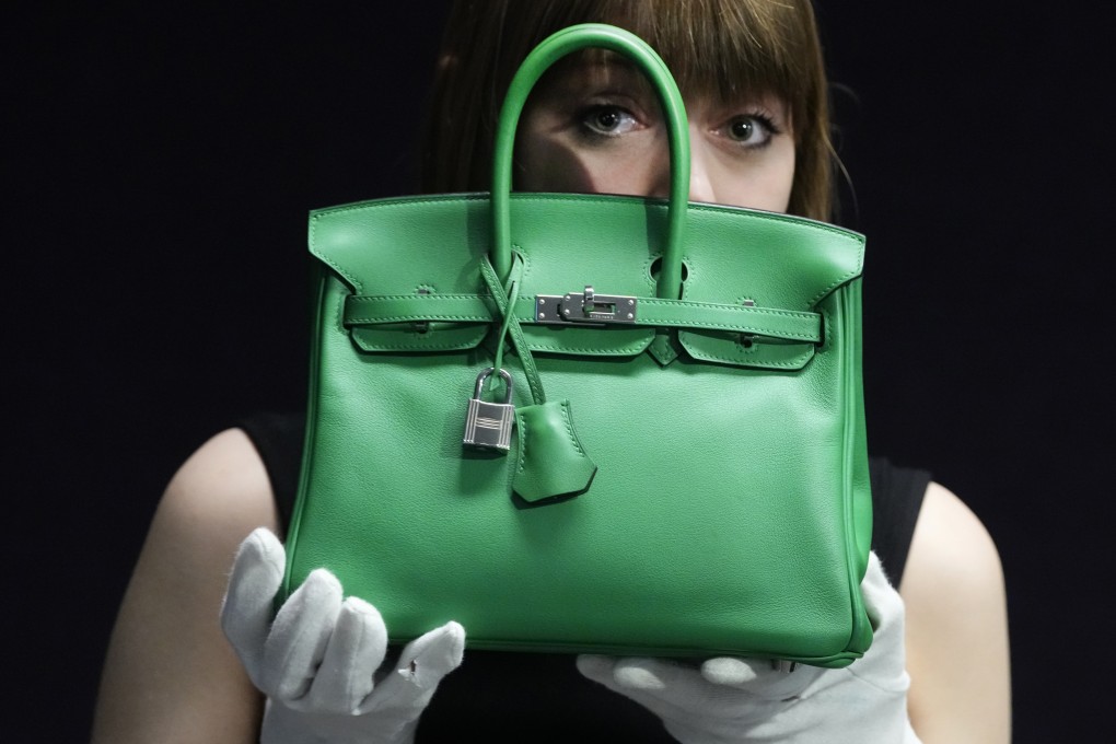 A Bonhams employee displays a Hermes Bambou Swift Leather Birkin 25 bag in London in February. Photo: AP