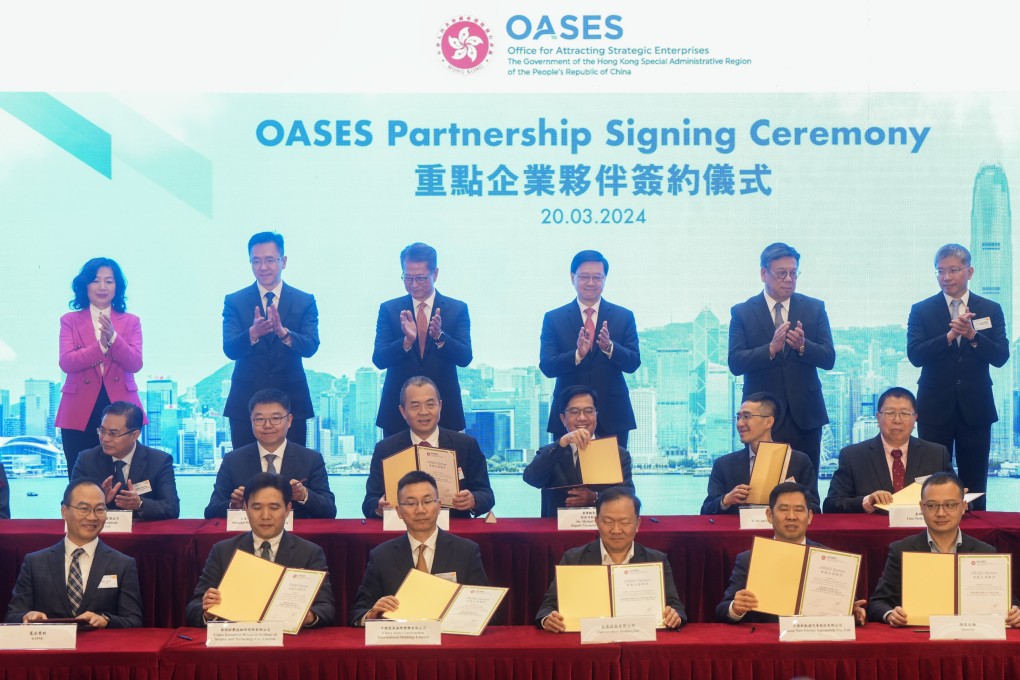 Chief Executive John Lee Ka-chiu (back row, fourth left) and Financial Secretary Chan Mo-po (back, third right)  attend the Oases Partnership Signing Ceremony at Central Government Office in Admiralty, 20 March 2024. Photo: Sam Tsang