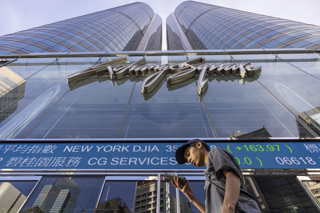A pedestrian passes by a Hong Kong Stock Exchange electronic screen in Hong Kong. Photo: AP