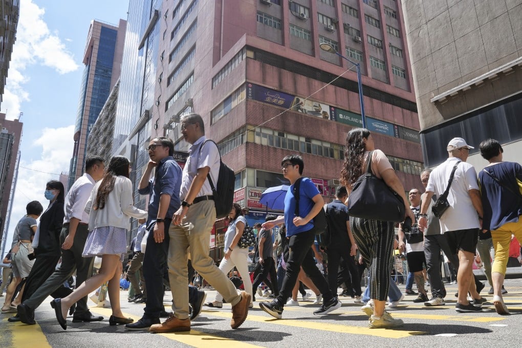 People cross a street in Hong Kong’s Kwun Tong commercial district on September 19, 2023. Photo: Elson Li
