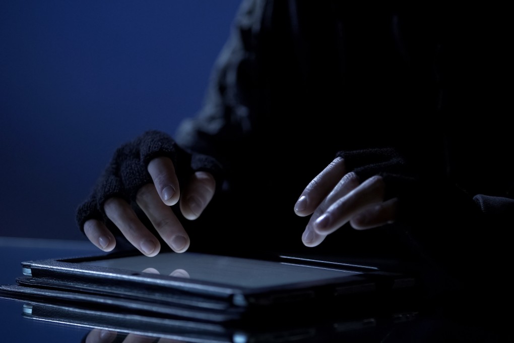 Man illegally viewing confidential files on a tablet. Photo: Shutterstock