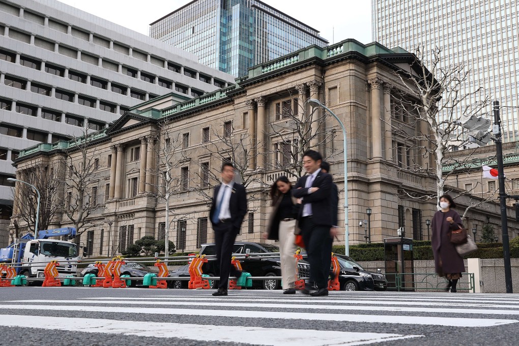 Pedestrians walk past the Bank of Japan headquarters in downtown Tokyo on March 19. Japan’s central bank has raised its key interest rate for the first time in 17 years, ending a long-standing policy of negative interest rates to stimulate the economy. Photo: dpa