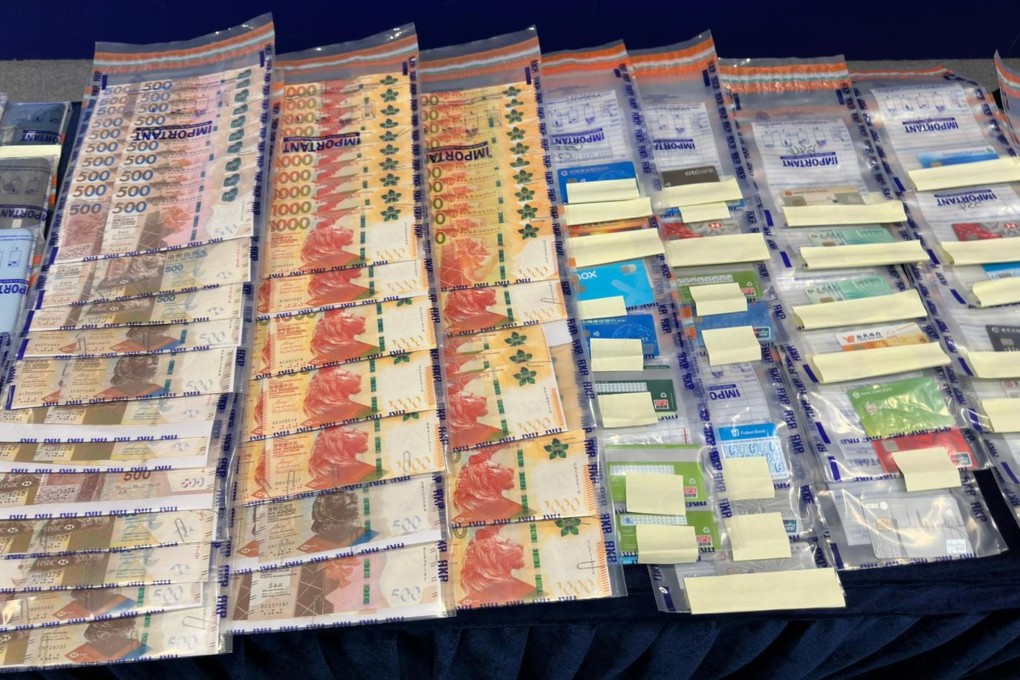 Evidence seized in the operation. Officers have confiscated HK$330,000 in cash, 57 bank cards and 40 mobile phones, among other items. Photo: Handout