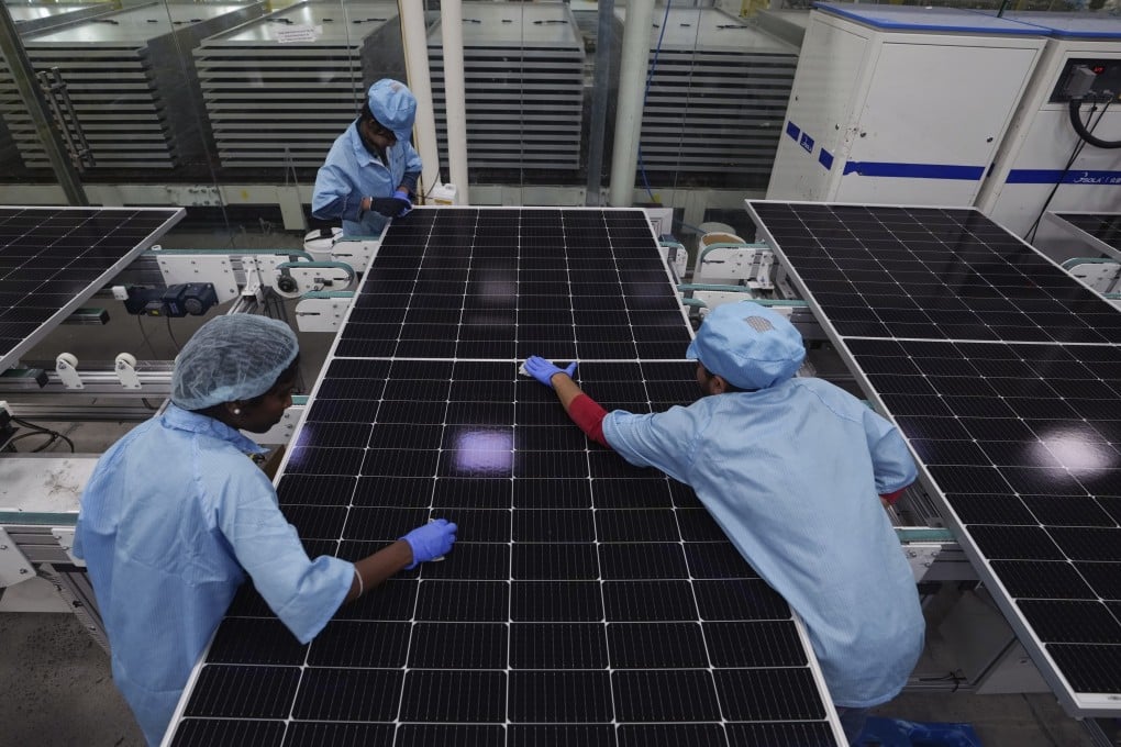 Workers clean solar panels at Premier Energies Solar on the outskirts of Hyderabad last year. India has introduced production-linked incentives for sectors such as electronics and renewable-energy equipment. Photo: AP