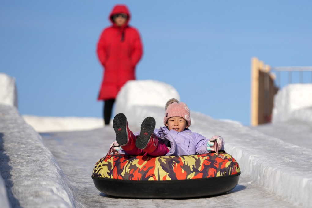 A child enjoys an ice slide at the Sun Island scenic spot in Harbin, Heilongjiang province. Photo: Xinhua