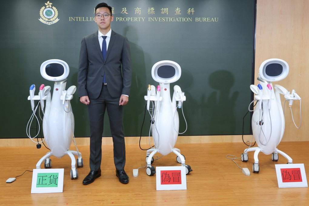 Inspector Vincent Kan of customs’ intellectual property investigation bureau with authentic and counterfeit skin treatment machines. Photo: Edmond So