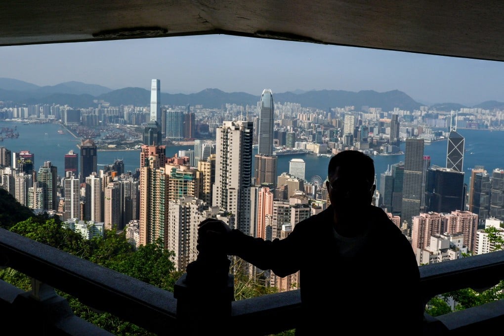 A tourist views the Hong Kong skyline from The Peak on March 20, 2024. Photo: Eugene Lee