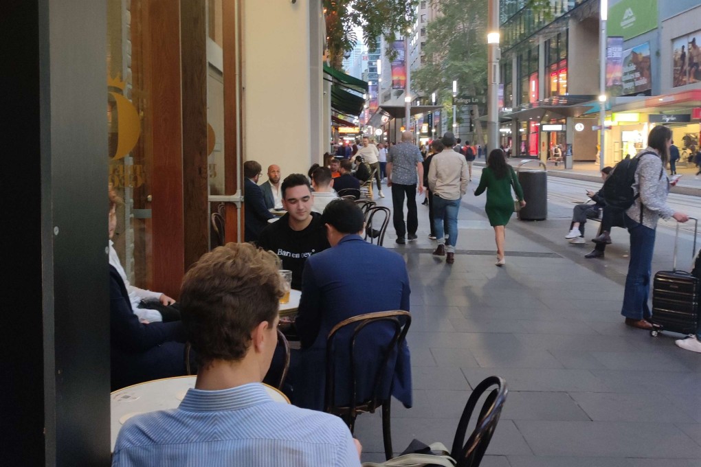 People sit outside a pub and restaurant in Sydney’s central business district on a recent weekday evening. Photo: Su-Lin Tan