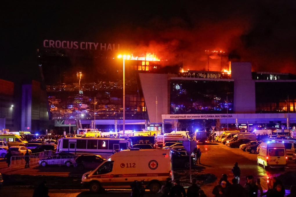 Ambulances and emergency vehicles sit outside the burning concert venue in Moscow, Russia where gunmen opened fire on Friday. Photo: Reuters