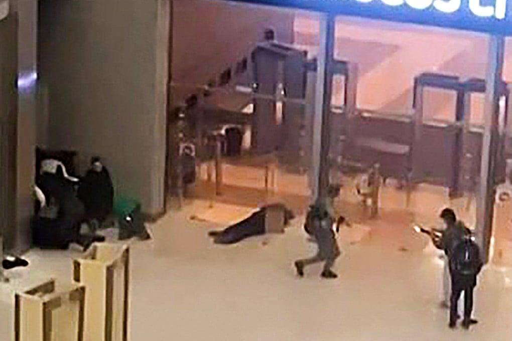 Gunmen moving towards the doors of the Crocus City Hall outside Moscow on March 22, 2024. Assailants opened fire ahead of a concert, killing more than 100. Photo: AFP