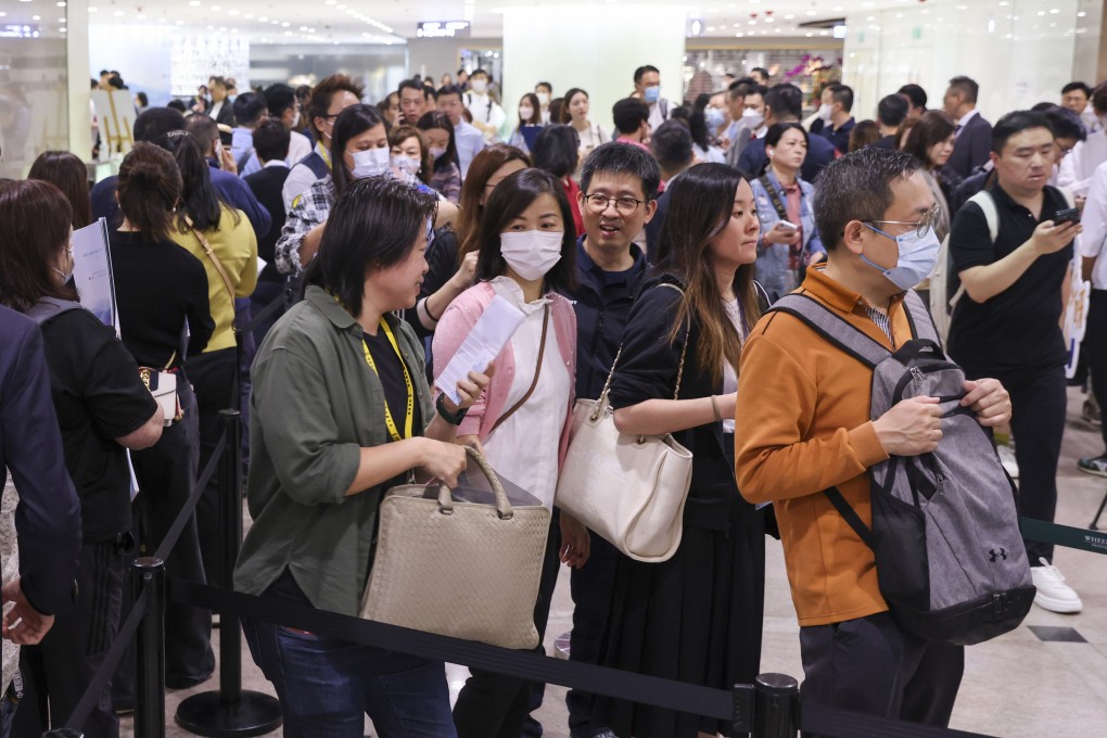 Potential home buyers line up for Wheelock Properties’ Seasons Place as it kicks off its first round of sales for 368 units on Saturday at the sales office in Tsim Sha Tsui.
Photo: SCMP / Yik Yeung-man
