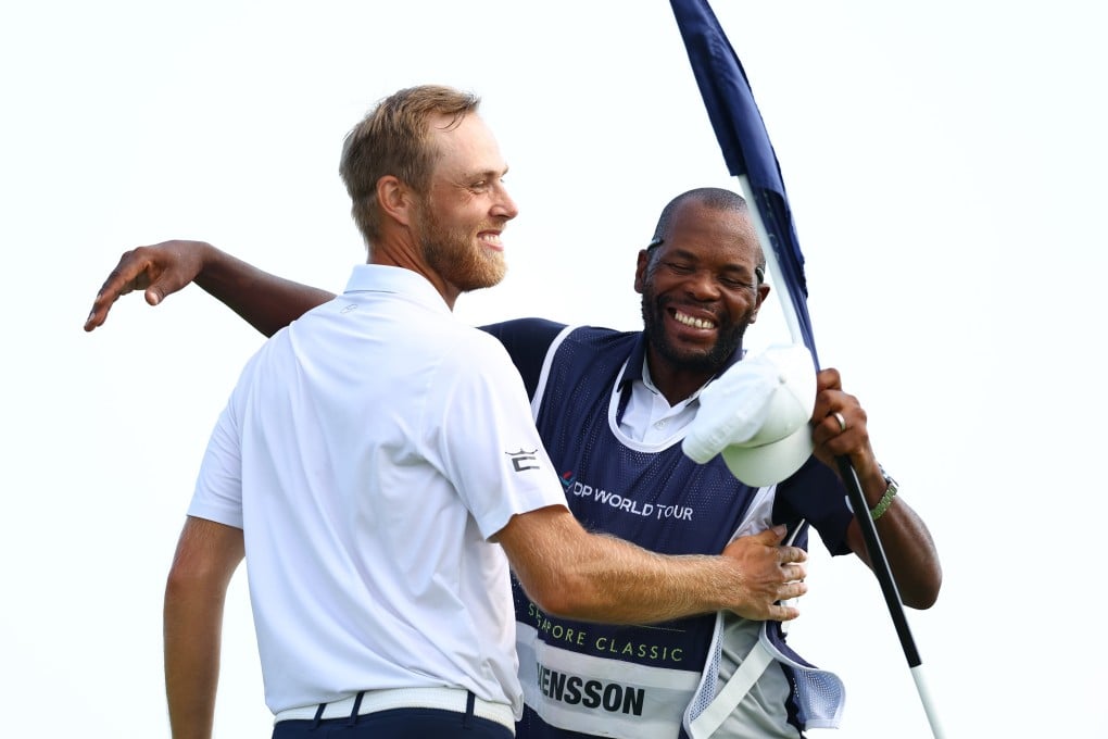 Jesper Svensson celebrates with his caddie after winning the Porsche Singapore Classic at Laguna National Golf Resort Club. Photo: Getty Images