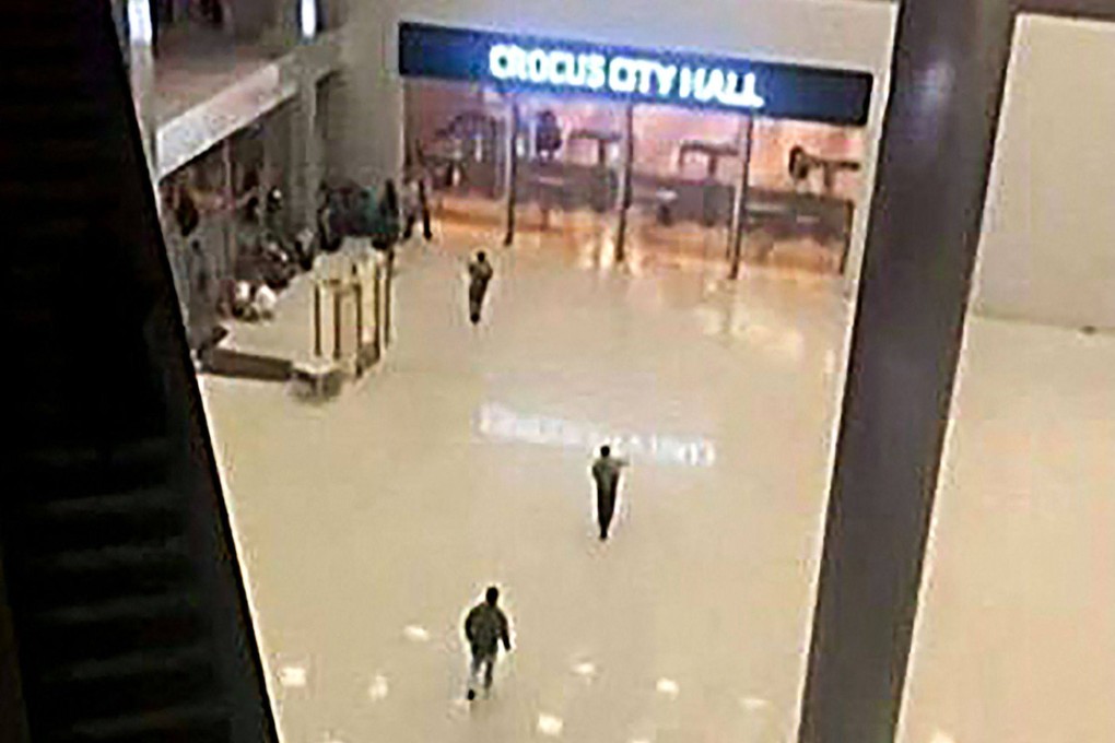 An still from footage obtained by AFP – not the video released by Islamic State – shows unidentified gunmen moving through the concourse of the Crocus City Hall, outside Moscow, late on Friday. Photo: UGC / UGC / AFP