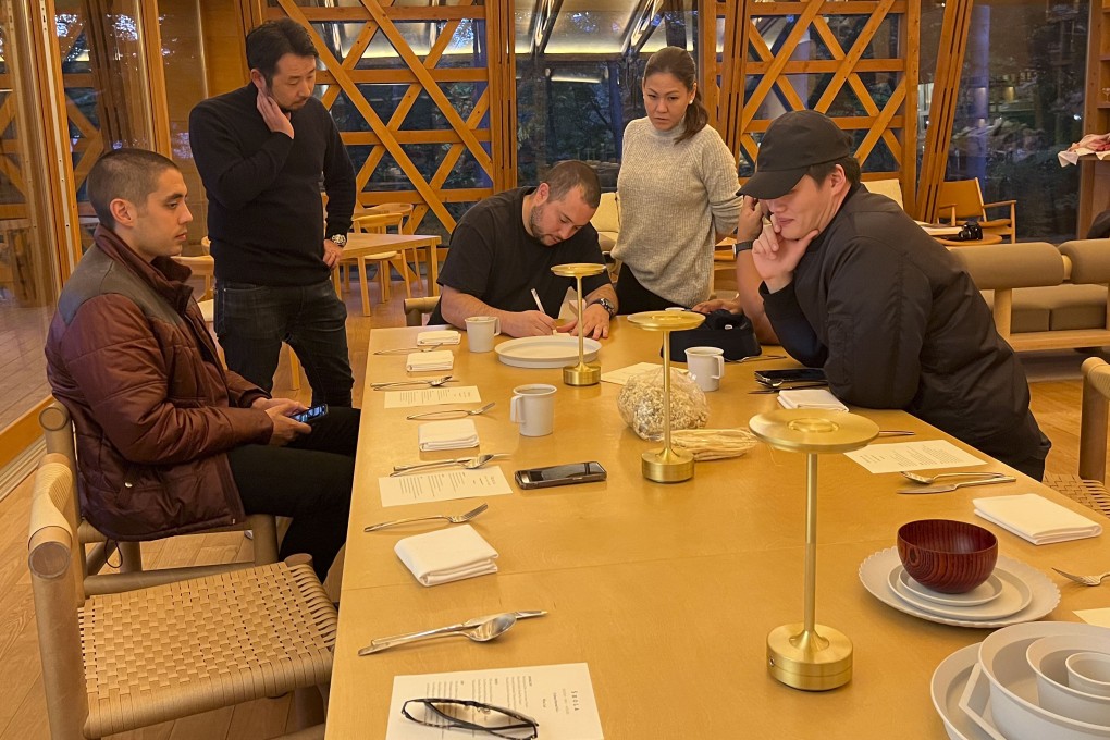 Top Asian chefs who came together at  Shishi-Iwa House,  a forested retreat north ot Tokyo, to cook a collaborative six-course meal discuss the menu for the meal after gathering fresh produce. Photo: Charmaine Mok